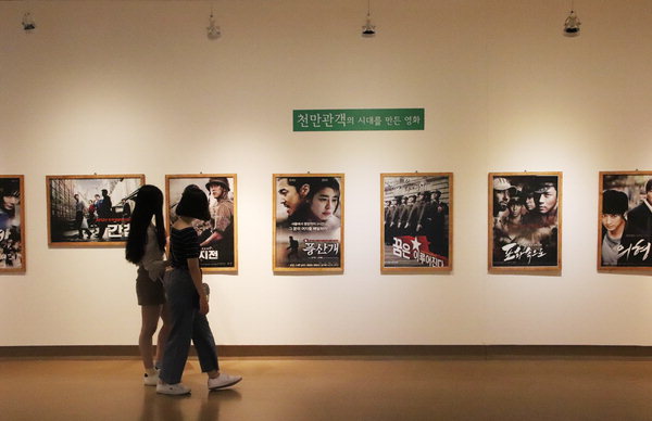 ▲ 관람객이 '영화 포스터로 보는 한국영화 100년' 전시를 둘러보고 있다. /이서후 기자
