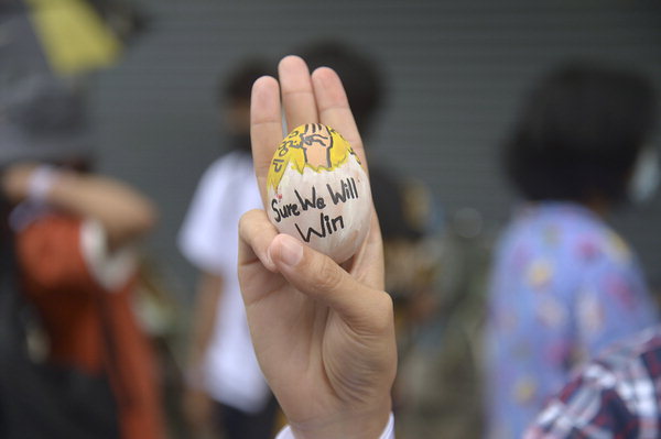 ▲ 지난 4일 미얀마 양곤에서 열린 군부 쿠데타 반대 시위 도중 한 시민이 손가락 세 개를 펴고 