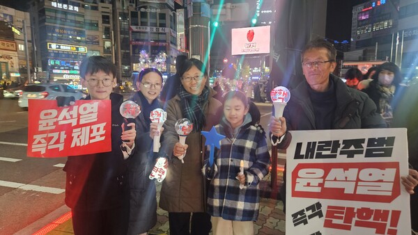 각자 좋아하는 가수 응원봉을 들고 통영촛불집회에 참가한 박종숙, 최순자 씨 가족.