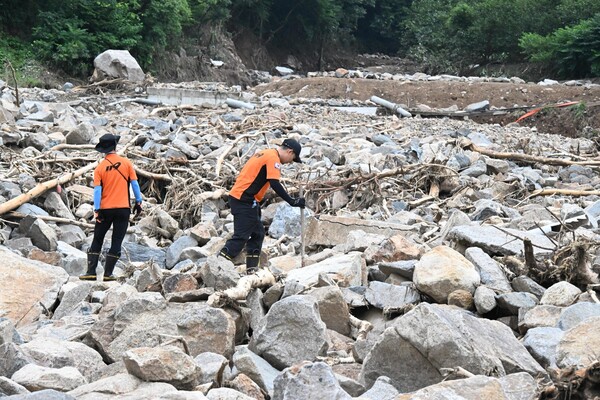 119구조대원들이 21일 오전 폭우로 밀려온 산청군 산청읍 모고리 모고마을 옆 계곡 돌무더기에서 실종자 수색작업을 하고 있다 ./김구연 기자