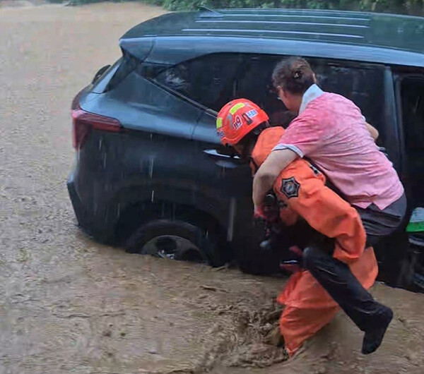 이종훈 산청소방서 산악구조대 소방장이 19일 오전 11시 37분께 산청군 산청읍 병정리 일대 도로를 순찰하다 불어난 물에 고립된 차량에서 60대 여성을 발견, 구조하고 있다. /산청소방서